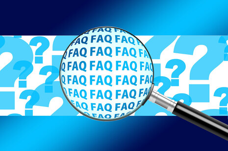 Illustration on the topic of Frequently Asked Questions: A magnifying glass highlights the abbreviation FAQ, while in the background there are many question marks